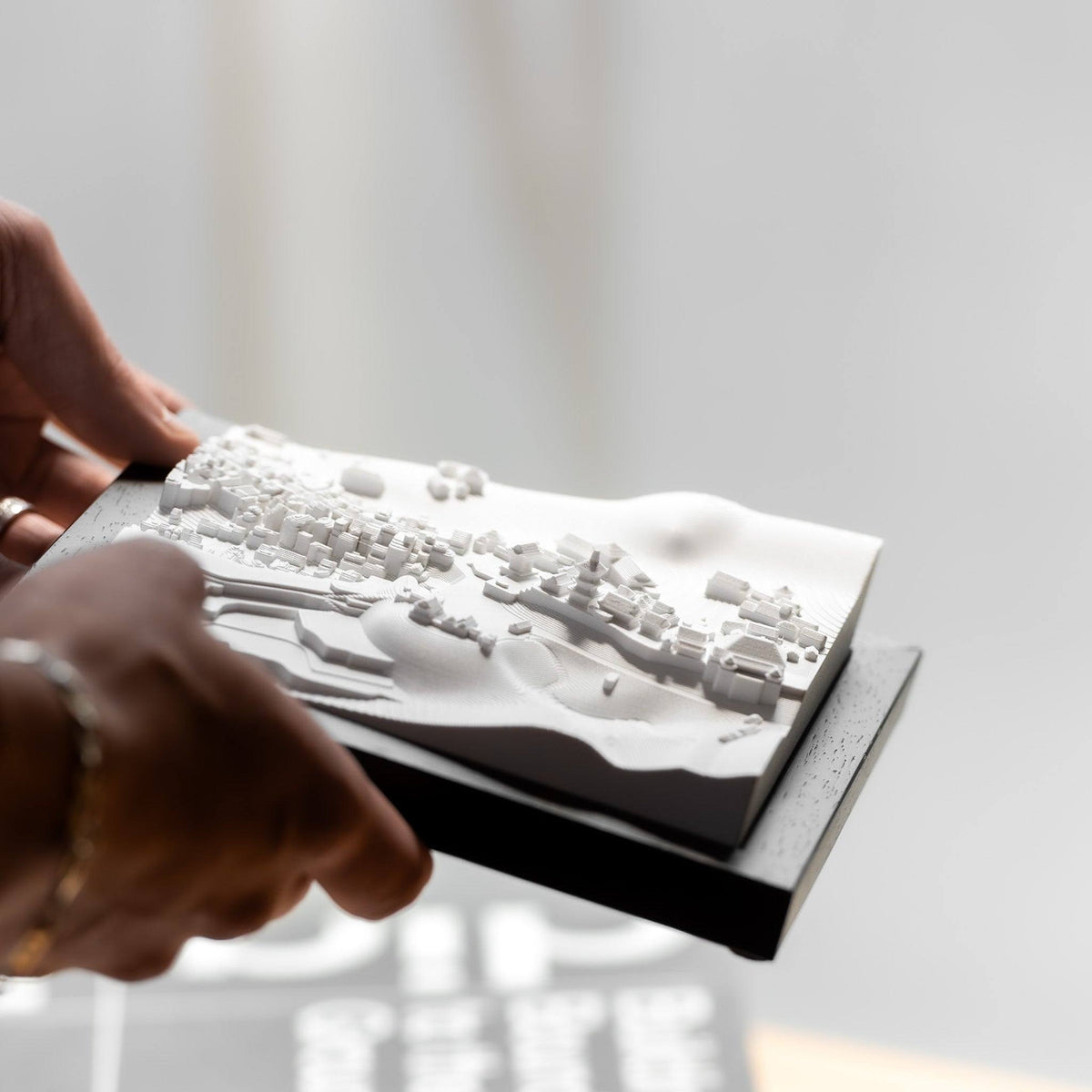 Hands holding a CUBE 3D city model of Kyoto with the Kiyomizu-dera temple on its hillside